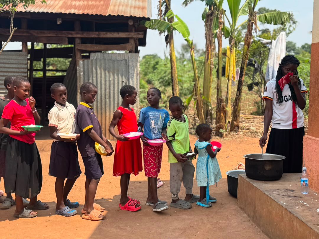 Children gathered near a meal service area